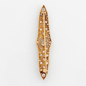 A platinum and 14K gold brooch set with an old-cut diamond weight ca 1.05 cts quality ca H si.