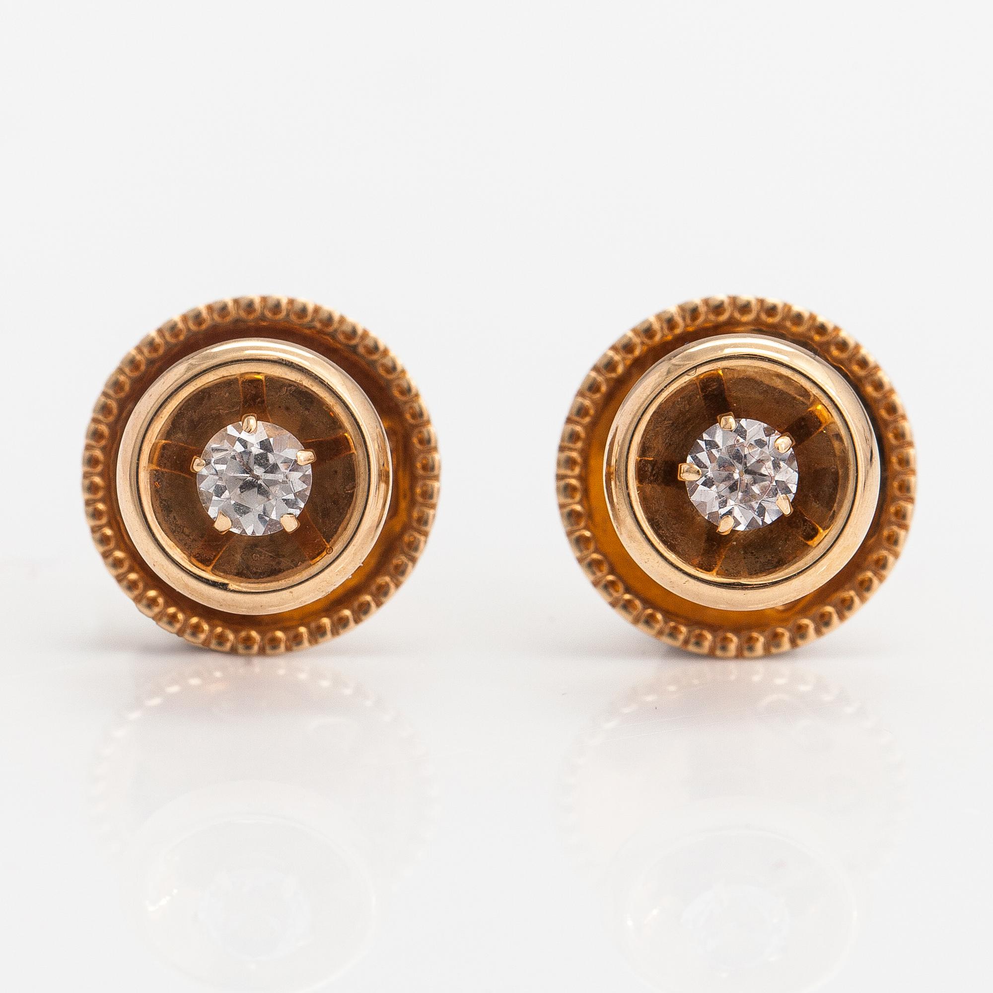Elis Kauppi,  A pair of 14K gold buttons with rock crystals to a white tie shirt. Kupittaan kulta, Turku.