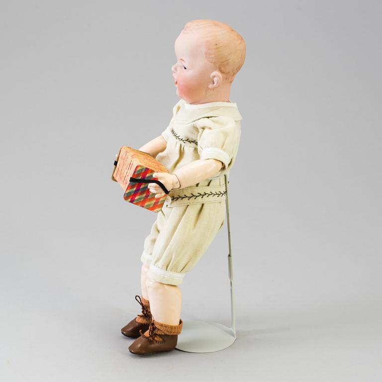 A bisque headed boy doll by Heubach, Germany, 1910s.
