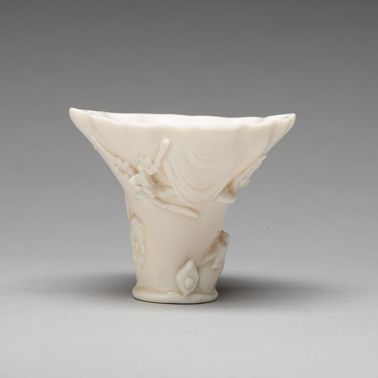 A blanc de chine rhinoserous shaped libation cup, 17th Century.