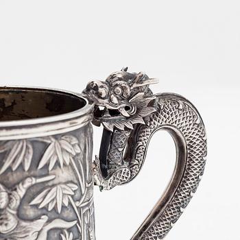 A Chinese export silver battle scene mug, retailer Leeching, latter half of the 19th century.