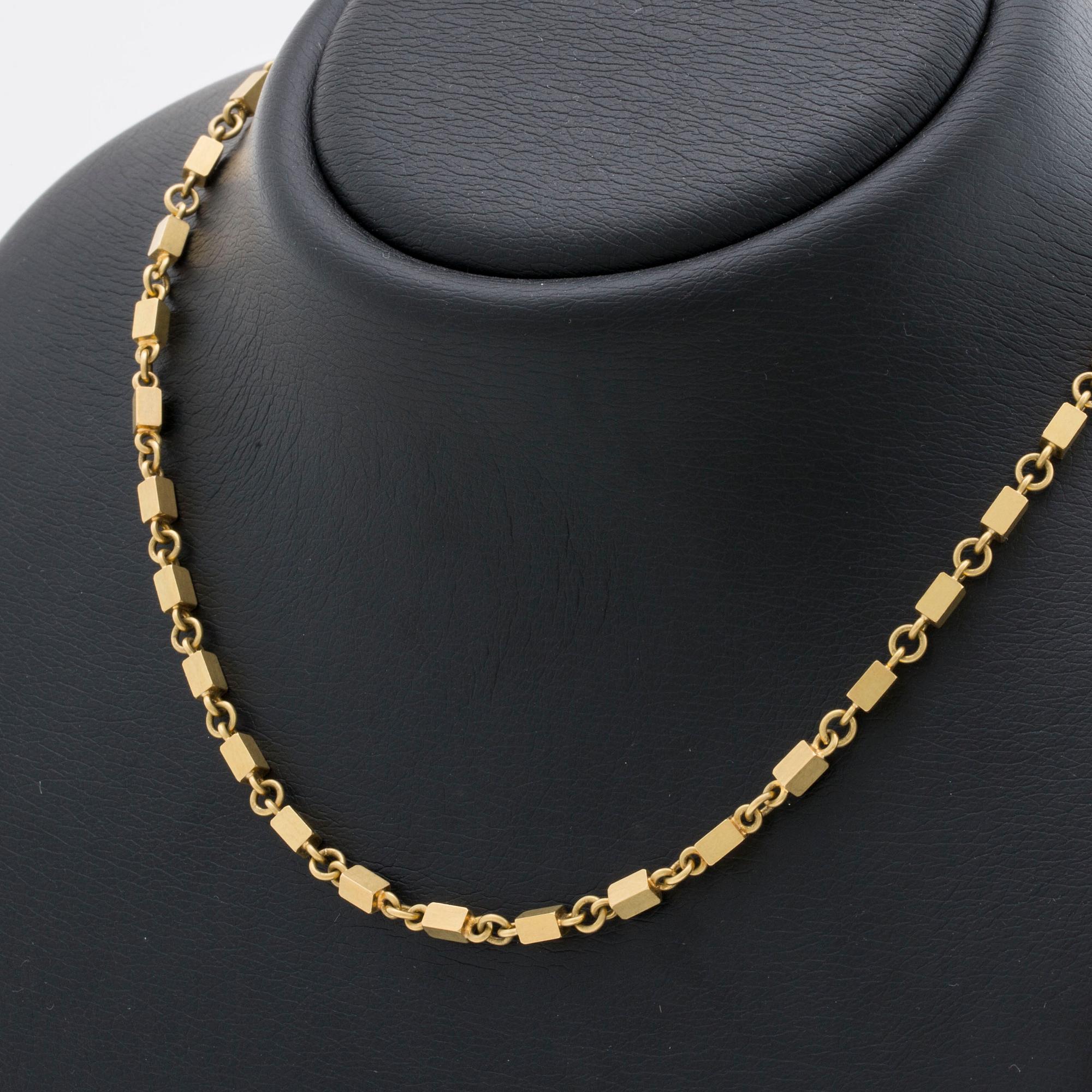 WIWEN NILSSON COLLIER 18K guld mindre stavar och ringar, Lund 1970, original etui.