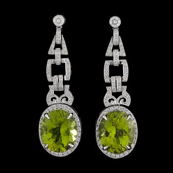 998. A pair of peridote 16.69 ct and diamond tot. 1.29 cts earrings.