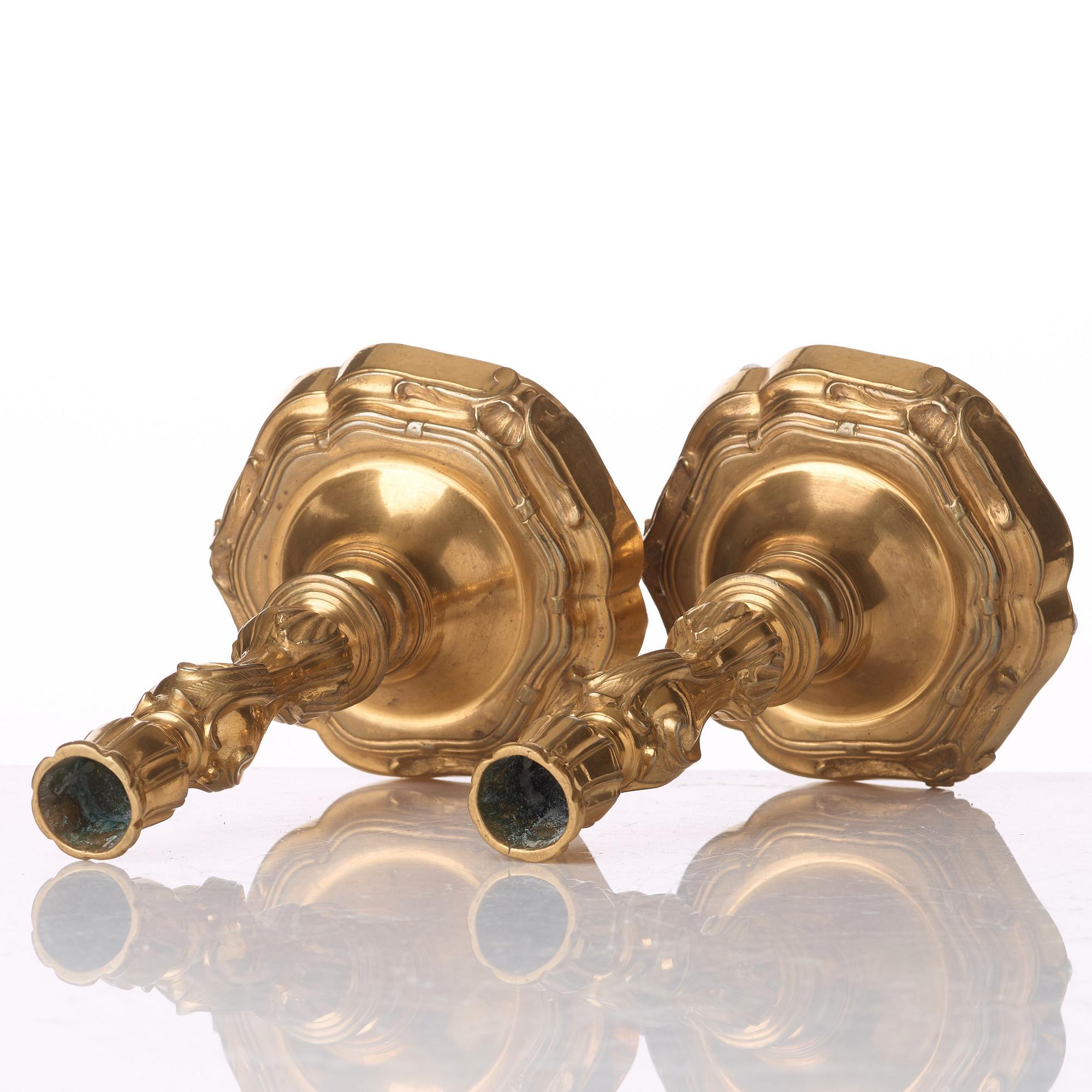 A pair of French Louis XV 18th century gilt bronze candlesticks.