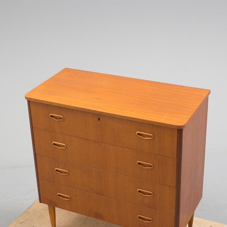 A second half of the 20th century teak veneered chest of four drawers.