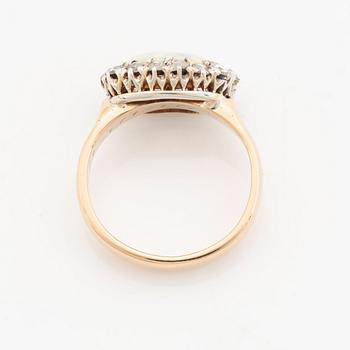 An 18K gold and opal ring set with rose-cut diamonds.
