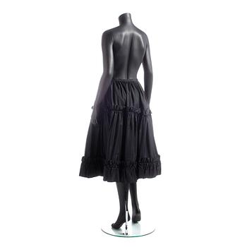 YVES SAINT LAURENT, a black silk skirt.