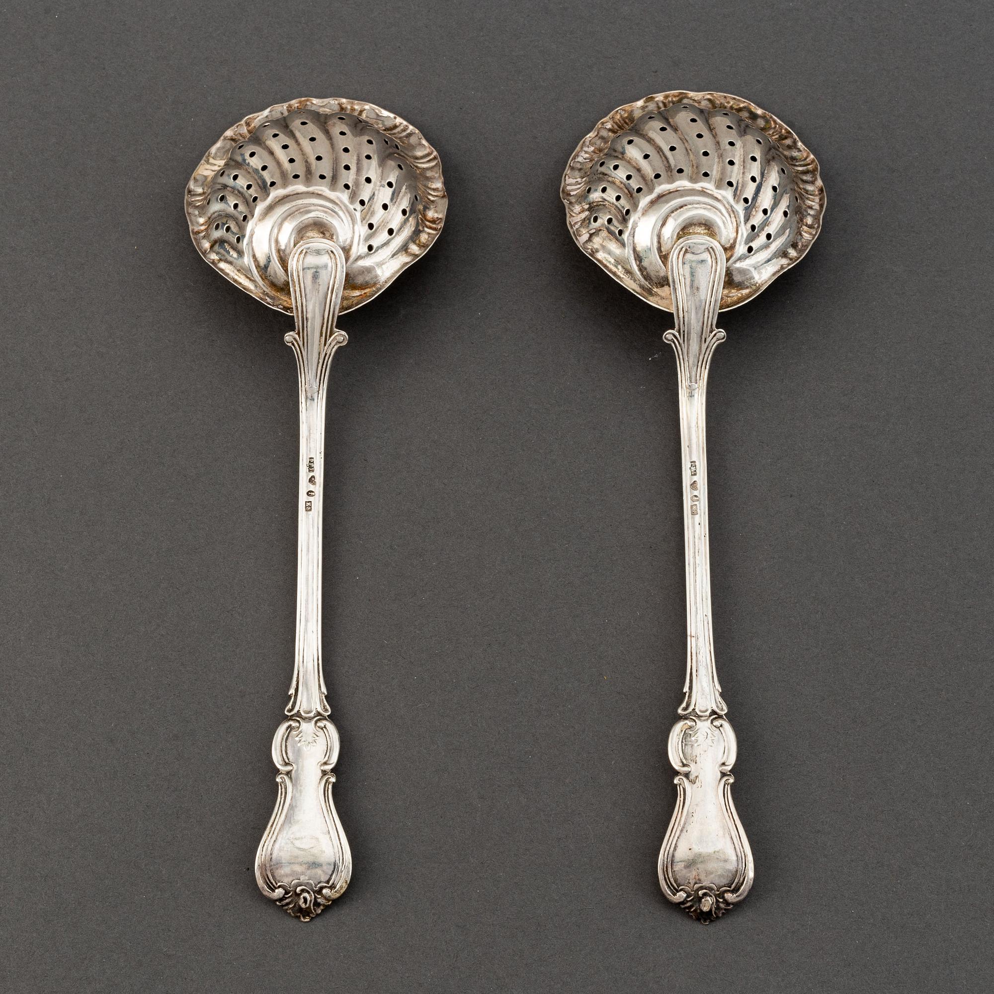 A pair of Swedish 19th century parcel-gilt silver caster-spoons, mark of PF Palmgren, Stockholm 1864.
