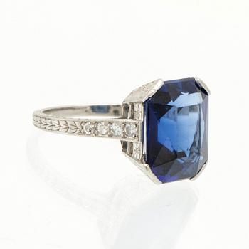 A Shreve & Co Platinum Ring set with a Synthetic Sapphire and Round Brilliant Cut Diamonds.