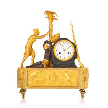 A figural Empire ormolu and patinated bronze mantel clock, early 19th century.