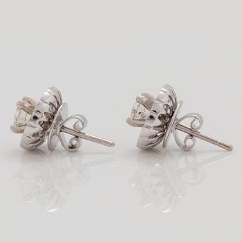 A pair of earrings with brilliant- and baguette- cut diamonds.