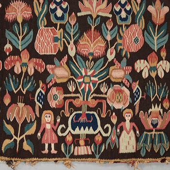 A CARRIAGE CUSHION. Tapestry weave. "Urnor och par". 48,5 x 101,5 cm. Southern Scania, Sweden, 19th century.