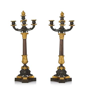 155. A pair of four-light ormolu and patinated Charles X candelabra, circa 1825.