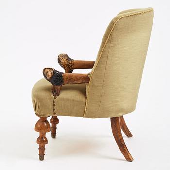 Swedish designer, a stained and carved birch folkart chair, ca 1900.