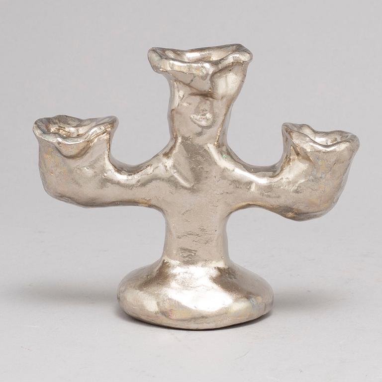 DAN WOLGERS, a silvergilt bronze candle stick, signed.