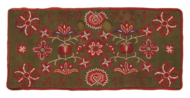 An embroidered carriage cushion, ca 51 x 113 cm (with mounting 61 x 122 cm) signed and dated END JPLG ANO 1838, Scania.