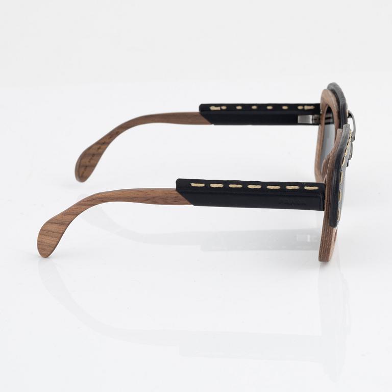 Prada, a pair of wood and leather sunglasses.