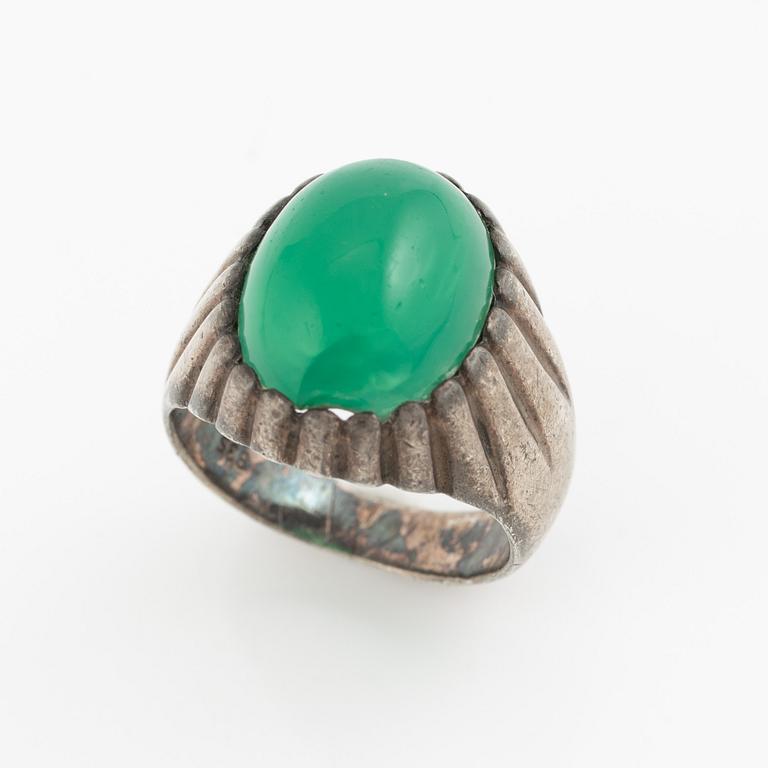 Silver ring with a green cabochon-cut stone.