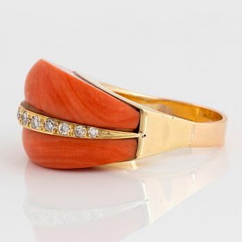 An 18K gold and coral ring set with eight-cut diamonds.