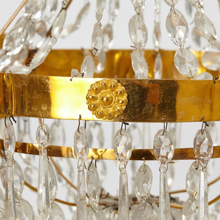 A late Gustavian gilt-brass and cut-glass four-branch chandelier, circa 1800.