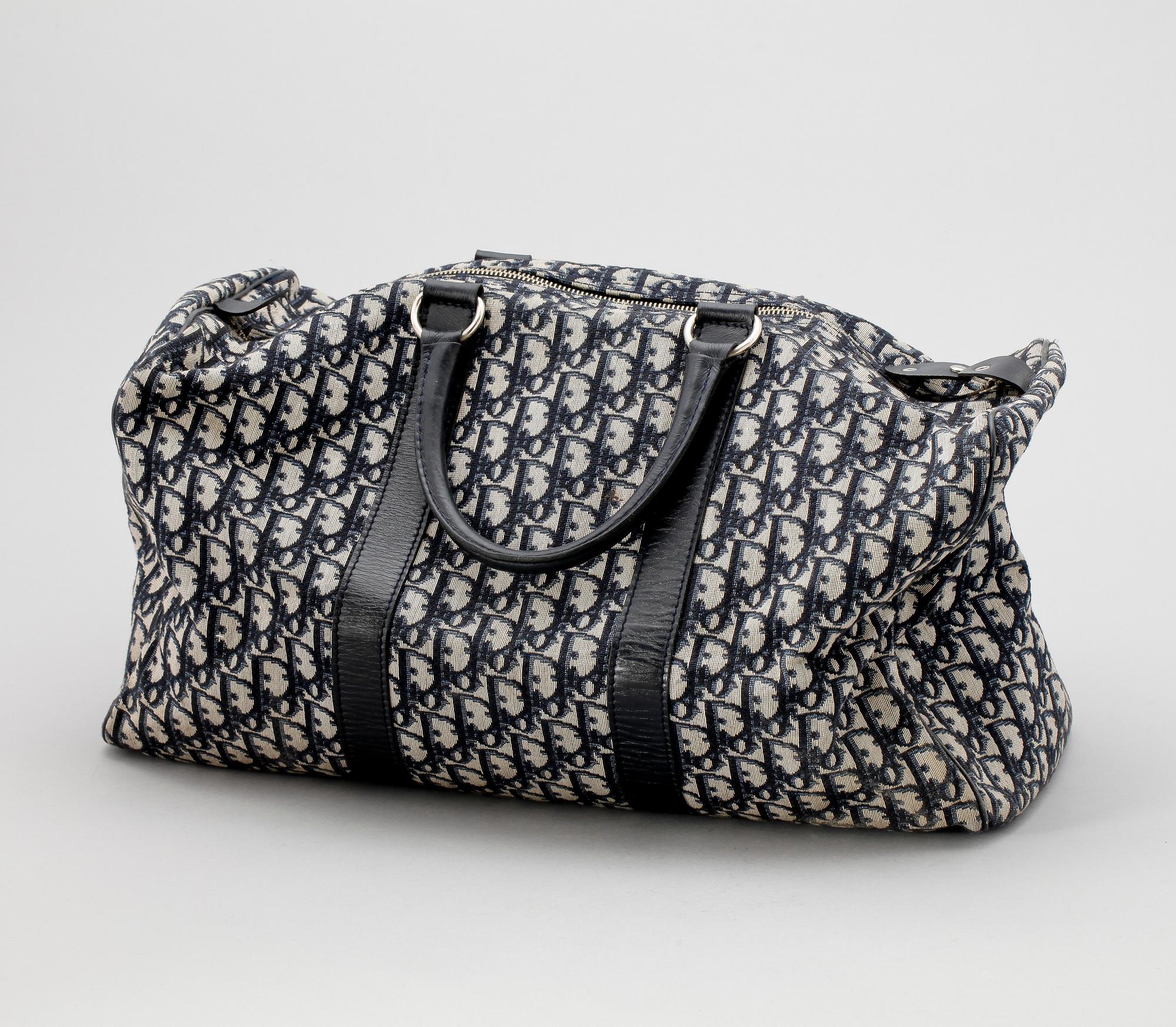 A blue monogram canvas weekendbag by Christian Dior.