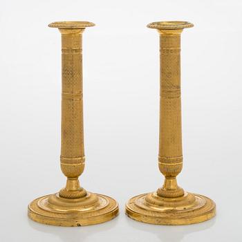 A pair of early 19th century French Empire candlesticks.
