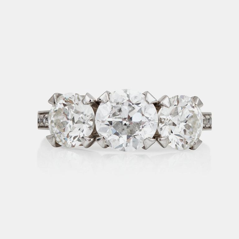 An old-cut three stone diamond ring. Total carat weight circa 3.90 ct.