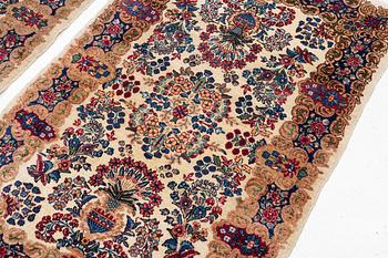 A pair of similar Kirman rugs, south Persia, c. 147 x 94 and 154 x 96 cm.