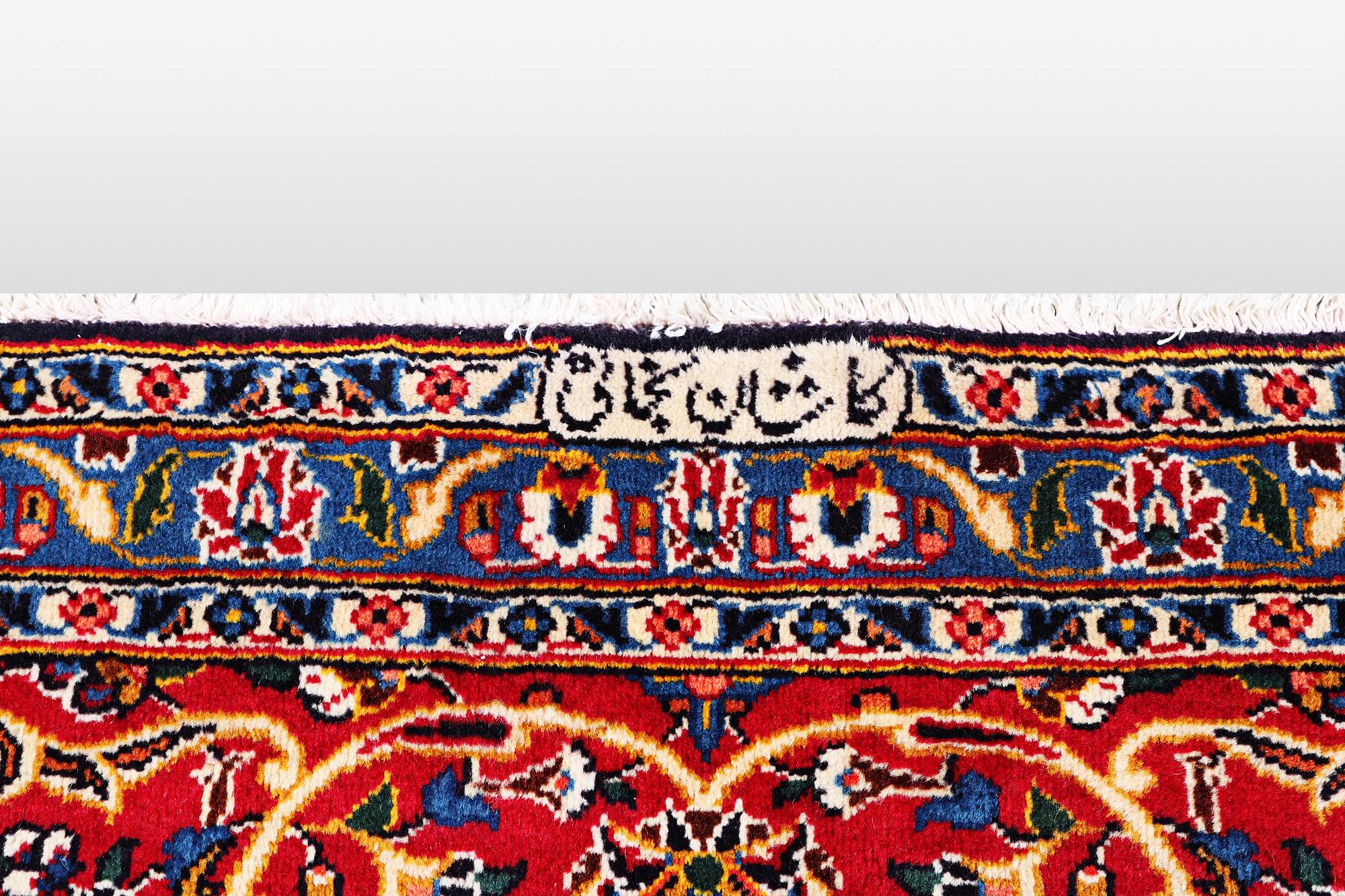 A carpet, Kashan signed Najafi, ca 360 x 231 cm.