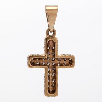 A 14K gold cross pendant with diamonds.