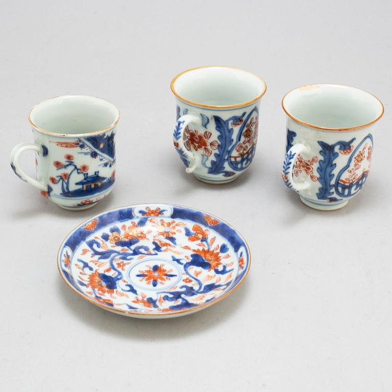 A pair of imari cups and a cup and saucer, Qing dynasty, 18th century.