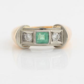 An 18K gold ring set with a step-cut emerald and round brilliant-cut diamonds.