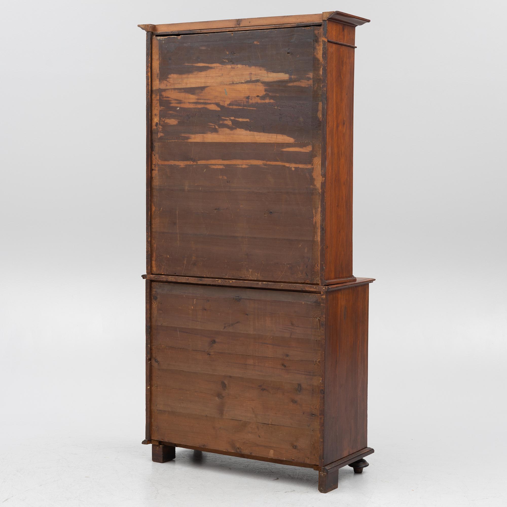 A two part mahogany cabinet, around 1900.