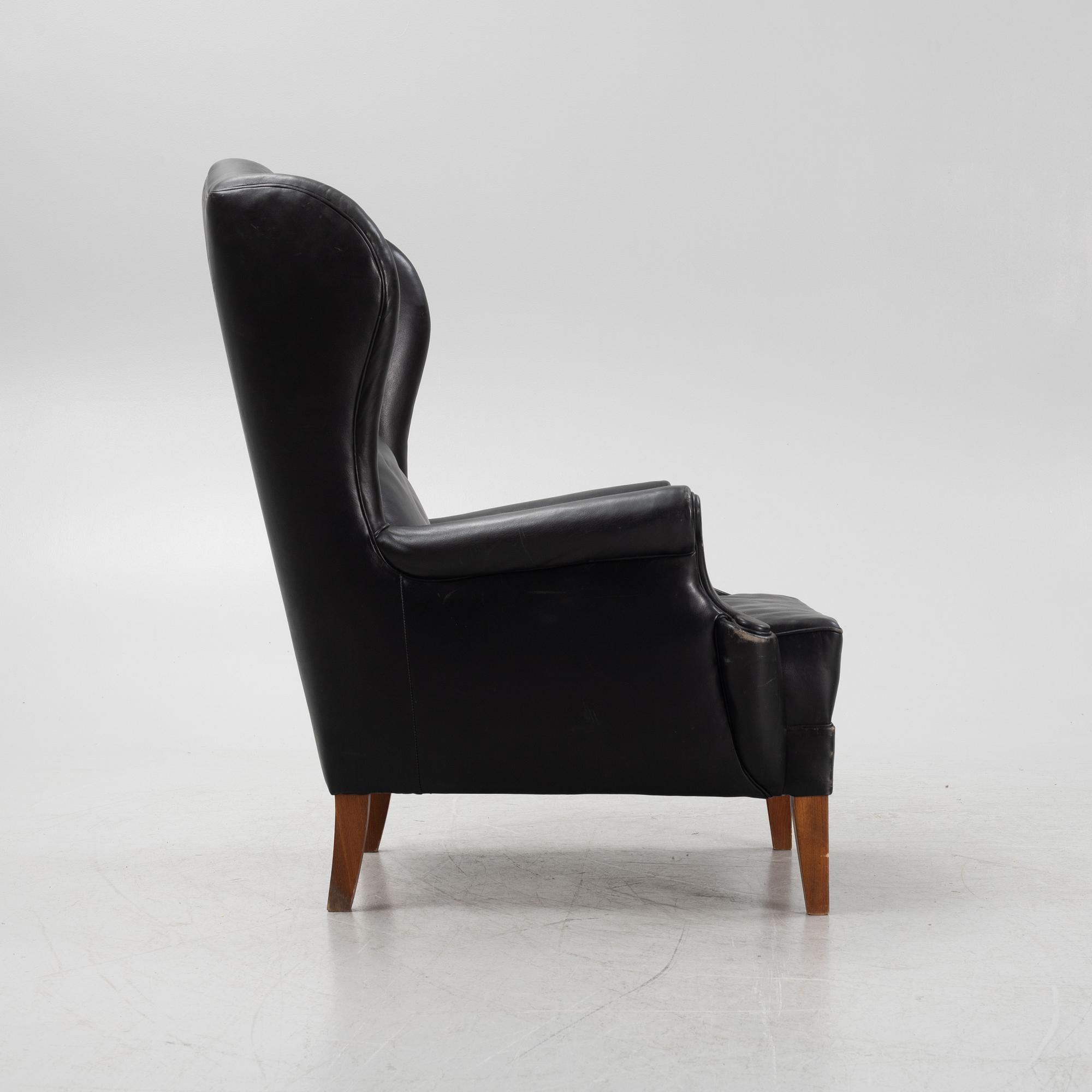A leather upholstered wingback chair, 20th Century.