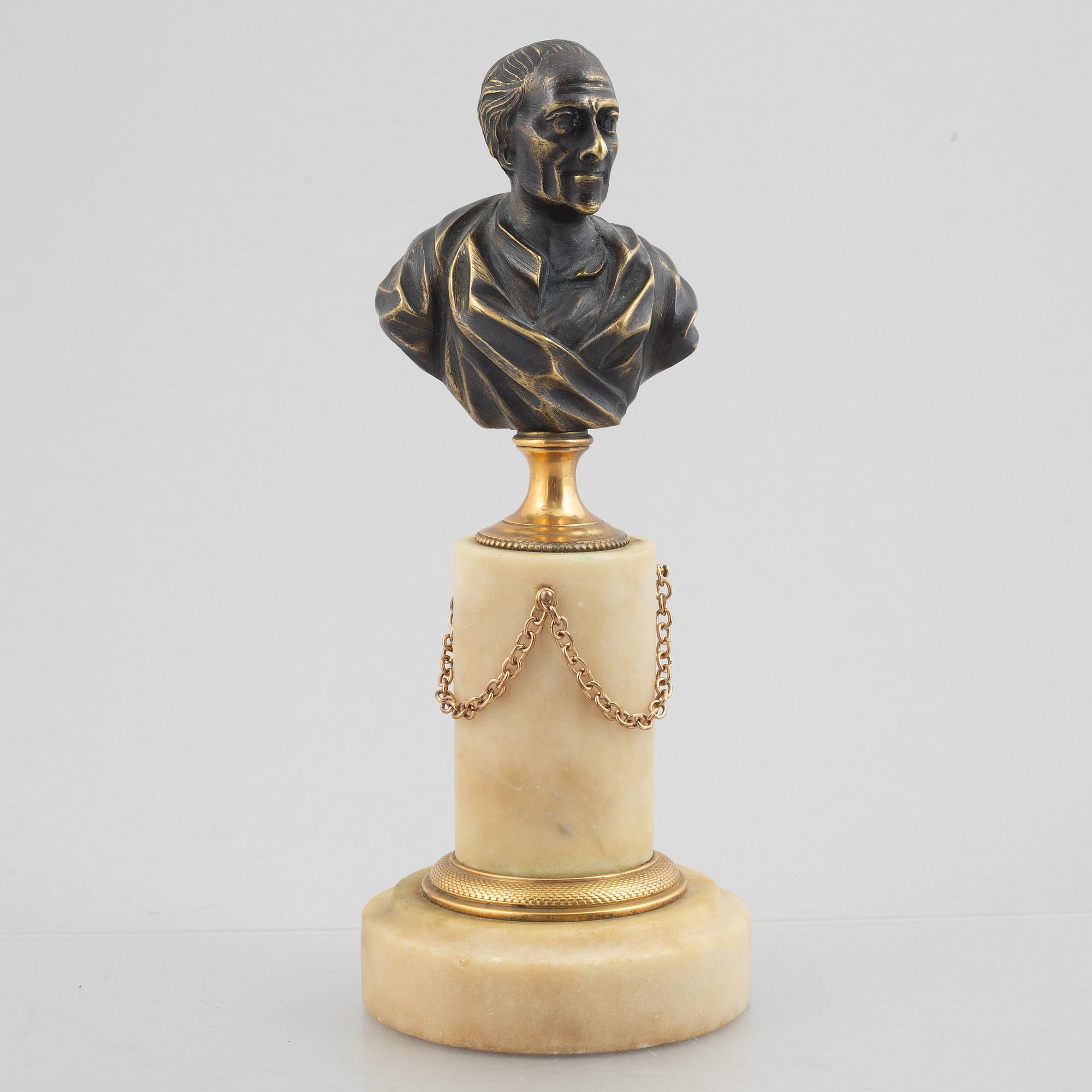 A Louis XVI patinated bronze and marble library bust of Voltaire, late 18th century.
