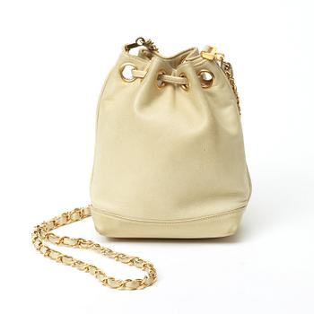 A 1980s cream colored shoulder bag by Chanel.