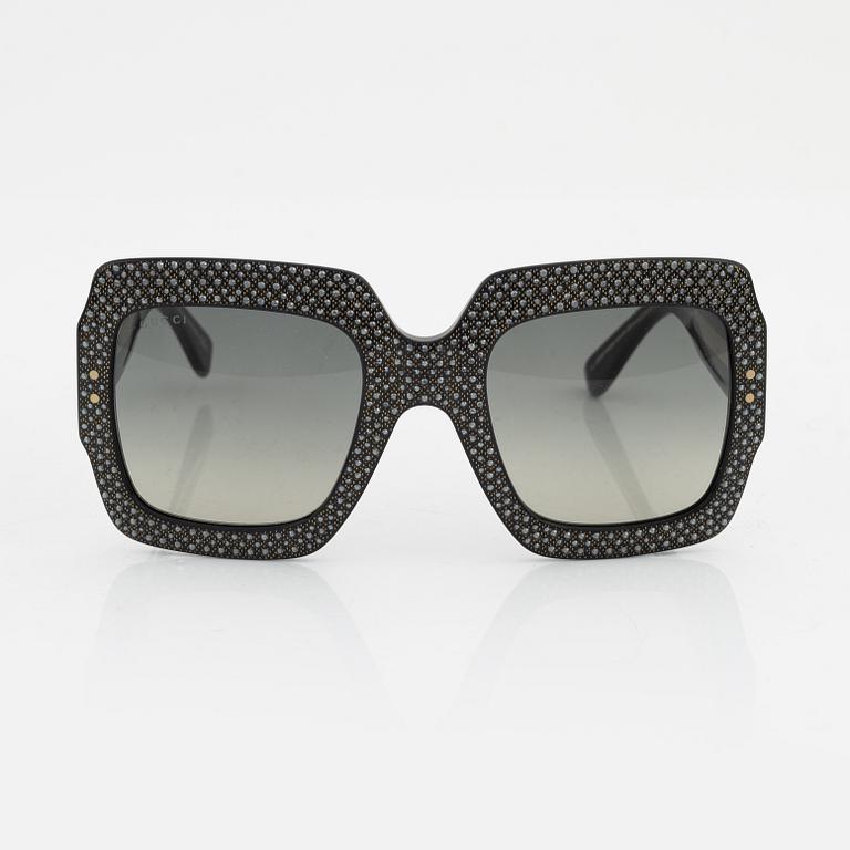 Gucci, a pair of black plastic and rhinestone sunglasses.