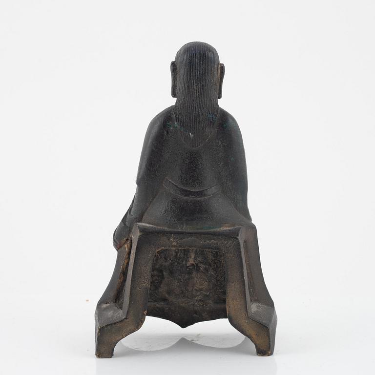 A bronze sculpture of a seated deity, Ming style, probably 20th Century.