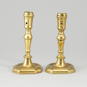 A pair of 18th century bronze candlesticks.