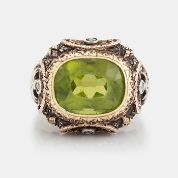 346. A silver and gold ring set with a faceted peridot and rose-cut diamonds.