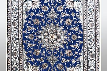 A Nain rug, part silk, ca 205 x 152 cm.