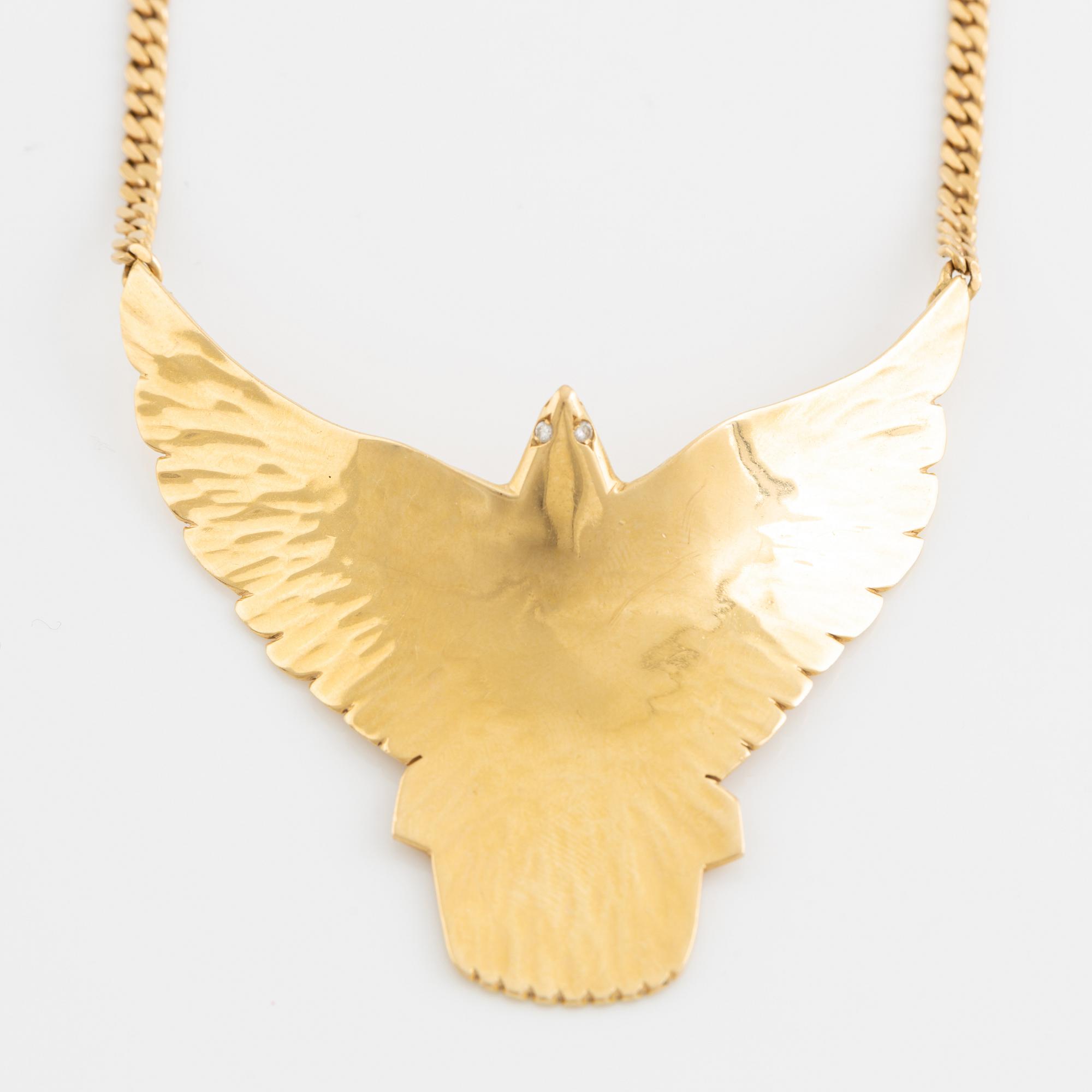 Gold and brilliant cut diamond bird necklace.