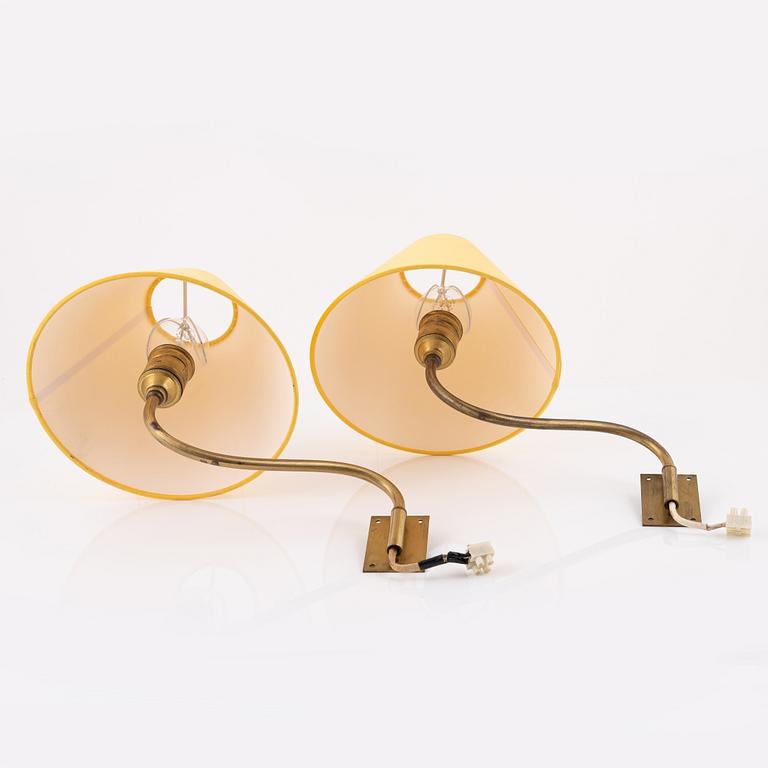 A pair of brass wall lamps.