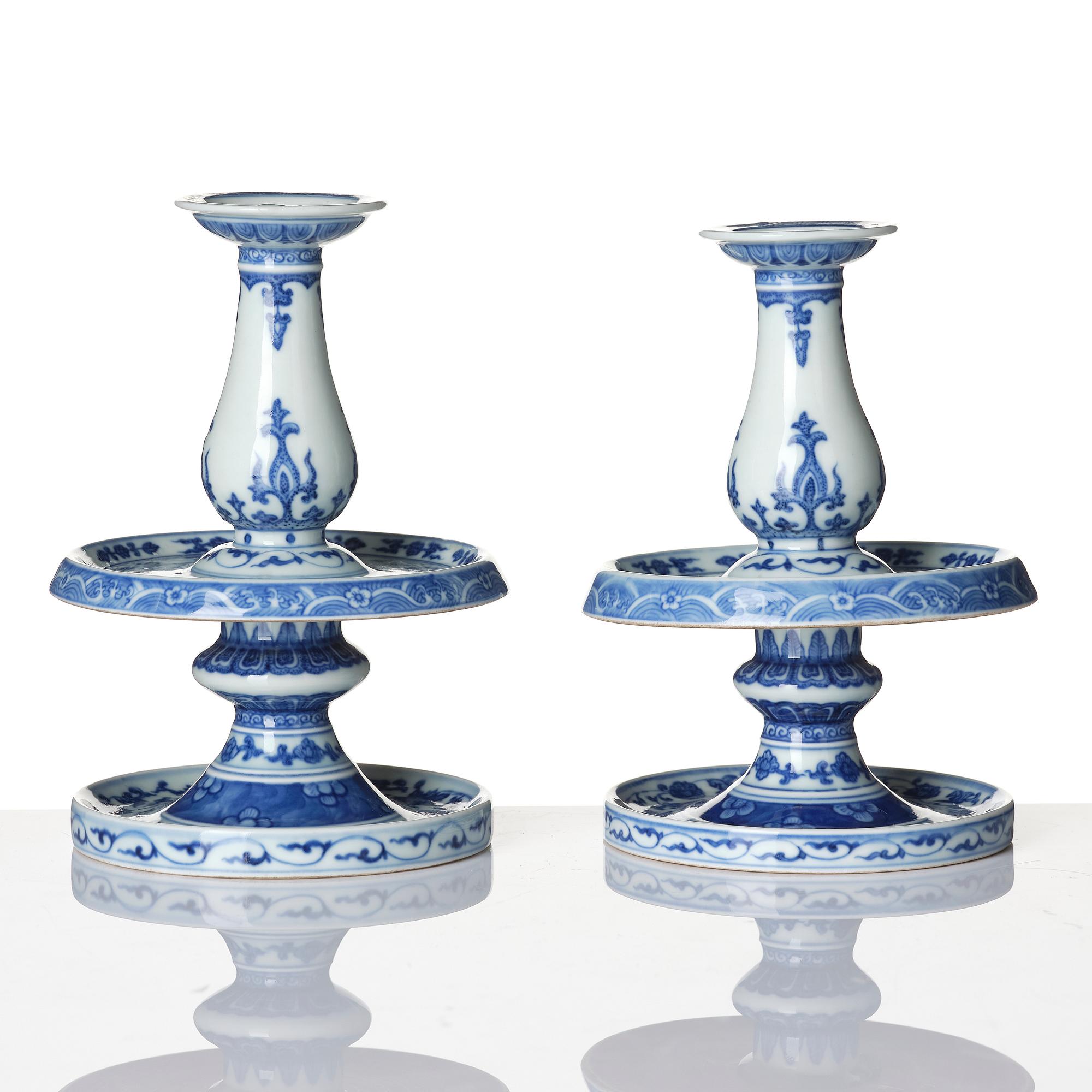 A pair of blue and white pricket candle sticks, with a poem, Qing dynasty with a Qianlong mark and of the period.