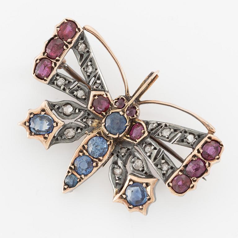 Brooch, in the form of a butterfly, set with sapphires and rubies and rose-cut diamonds.