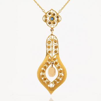 A necklace set with seed pearls, a cabochon cut sapphire, probably another sapphire and filigree work.