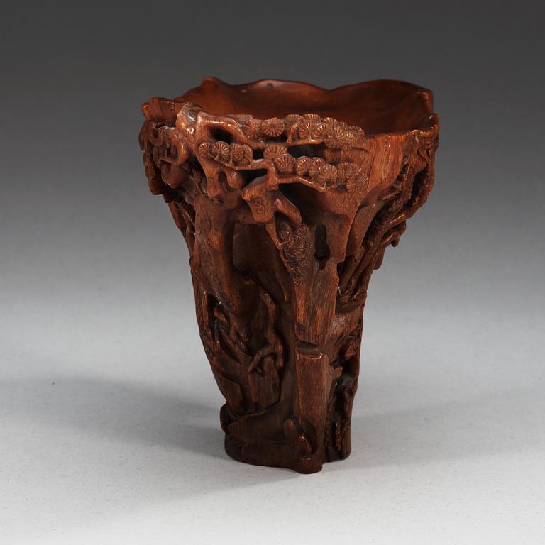 A finely carved rhinoceros libation cup, Qing dynasty, Kangxi (1662-1722).