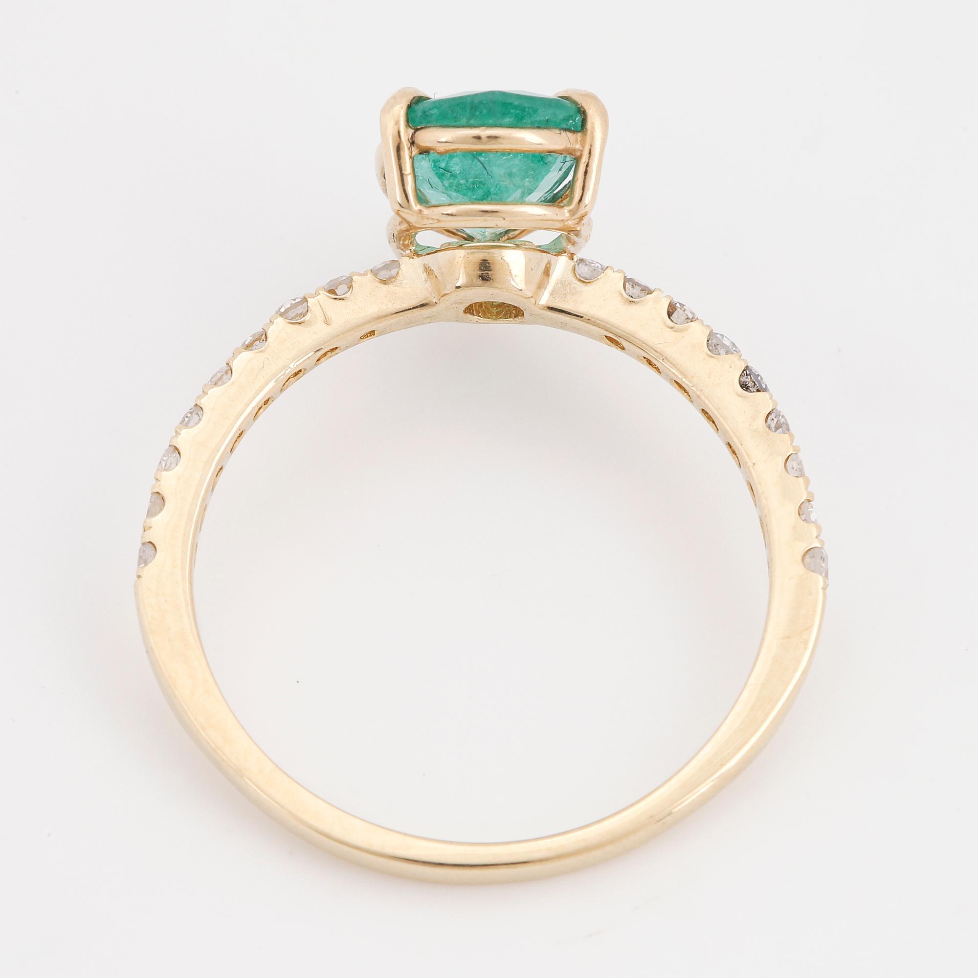 Pear shaped emerald and brilliant-cut diamond ring.
