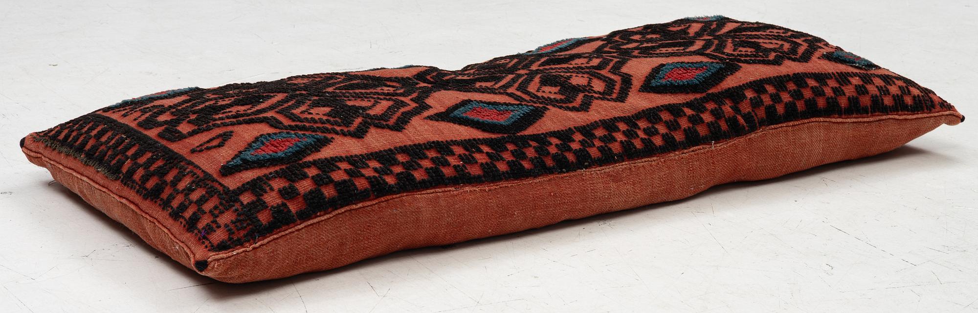 A carriage cushion, knotted pile in relief, ca 106 x 47, southwest of Scania, Sweden, circa 1800.