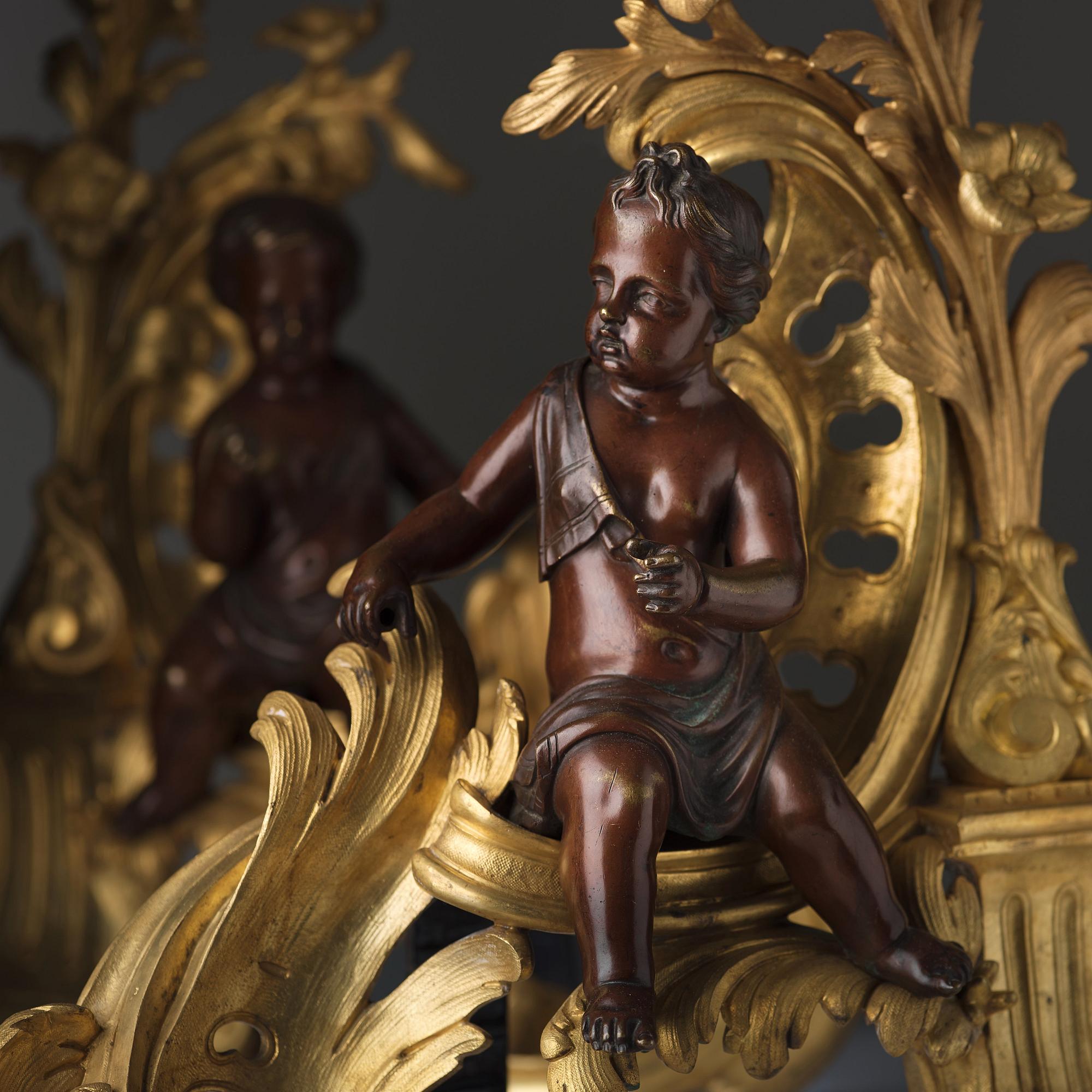 A pair of Louis XV-style 19th century fire dogs.